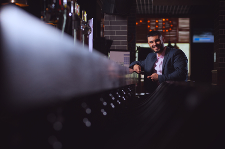 Positive handsome man businessman rests in barの写真素材