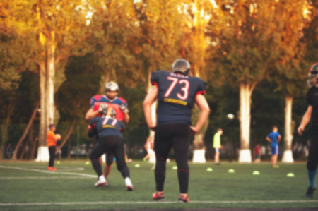 Blurry American football players in action.の写真素材