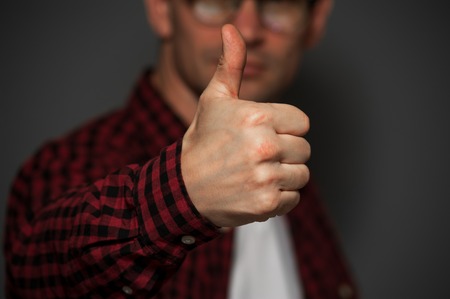 Young positive man with glasses and casual clothesの写真素材