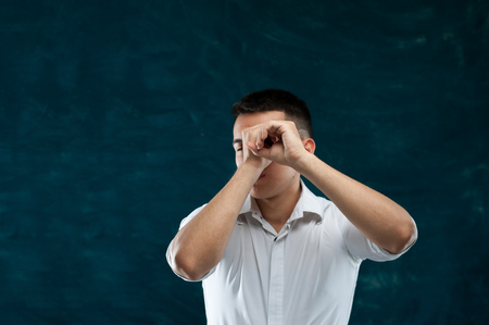 Attractive man posing on dark backgroundの写真素材