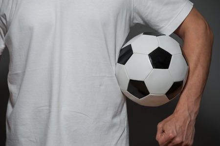 Closeup - male soccer or football player with ballの写真素材