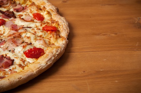 Fresh Italian pizza on wooden deskの写真素材