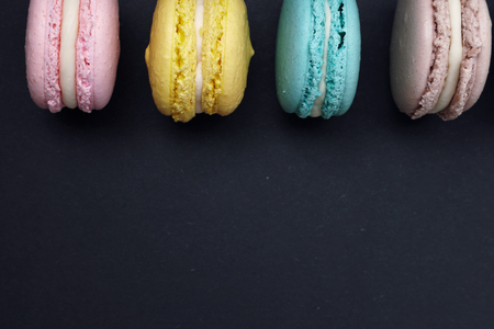 Flat lay pastel macaroons on dark backgroundの写真素材