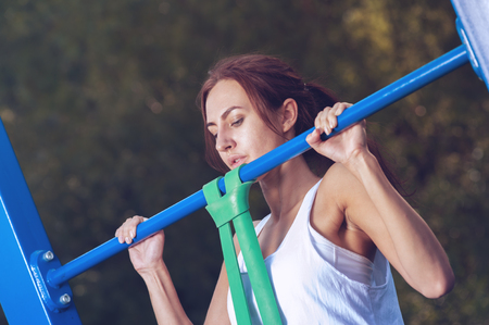Beautiful woman exercising in outdoors gym
