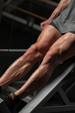 Strong young man working out in the gymの写真素材