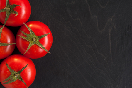 Cherry tomatoes on dark background.の写真素材