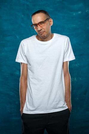 Cute man posing on blue backgroundの写真素材