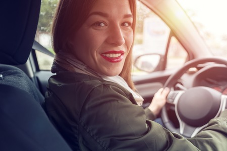 Woman sitting at the wheel of carの写真素材