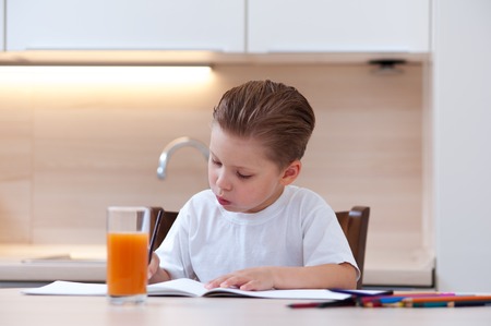 Cute boy in white T-shirt paint coloringの写真素材