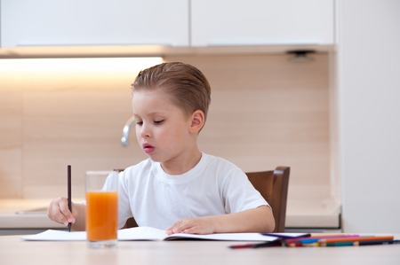 Cute boy in white T-shirt paint coloringの写真素材