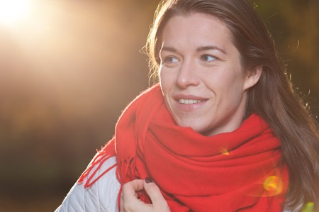 Happy positive woman in autumn parkの写真素材