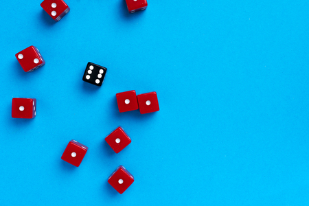 Red and black gaming dices on blue backgroundの写真素材