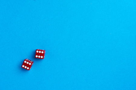 Red gaming dices on blue backgroundの写真素材