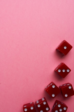 Red gaming dices on pink background