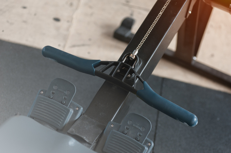 Close-up - row machine for intensive cardio workout in the gym. Sports and fitness concept.