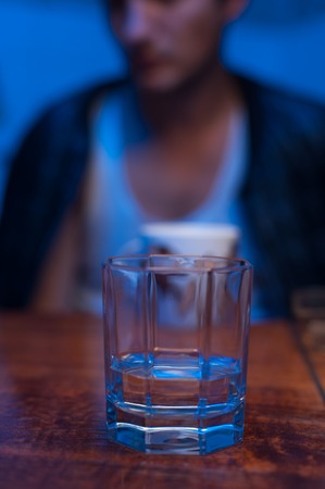 Close-up of male hands with glass of alcoholの写真素材