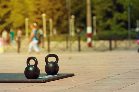 Kettlebells are standing on street in sports parkの写真素材
