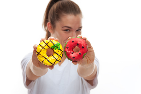 Close-up of two donuts in female handsの写真素材