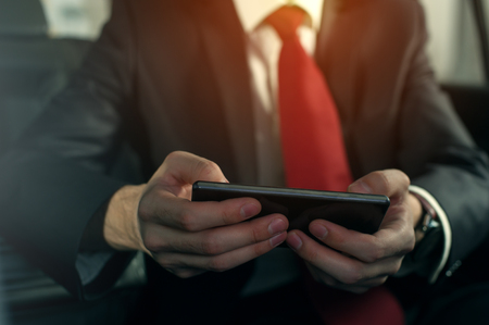 Close-up - young successful businessman sitting in the carの写真素材