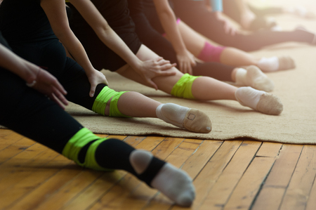 Gymnastic class row of girls legsの写真素材