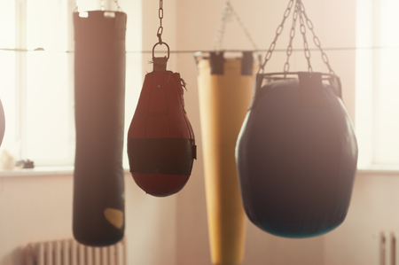 Row of boxing bags in the sports gymの写真素材
