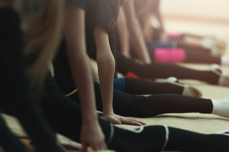 Young woman doing split exercise the gymの写真素材