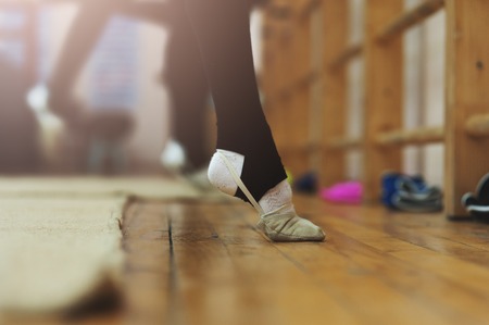 Close up of feet of young gymnast stretchingの写真素材