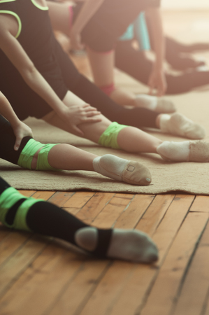 Gymnastic class row of girls legsの写真素材
