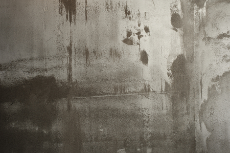 Distressed yellow brown pain on old brick wallの写真素材