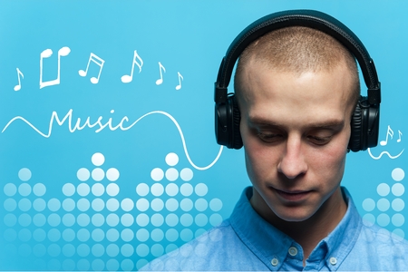 Handsome guy DJ in headphones listening to music