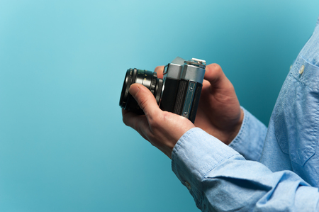 Hands of a young male photographerの写真素材