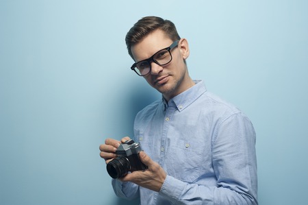 Young male photographer holding a new camera