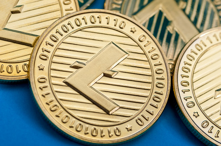 Group of golden litecoin coins, close-up.