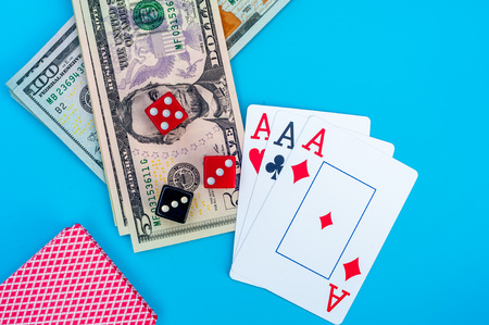 Playing Cards, Gaming Dices and Dollar Bills Stack on Background