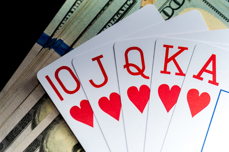 Playing Cards and Stack of American Dollars Bills.の写真素材