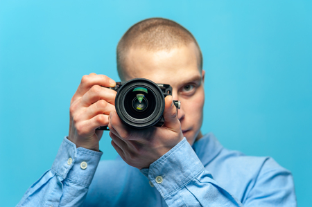 Young male guy photographer with dslr cameraの写真素材