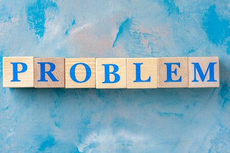 Wooden cubes with word PROBLEM on blue table.の写真素材