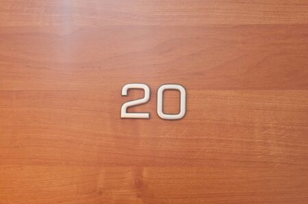 Table number twenty hanging on a wooden door