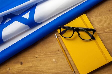 Top view of flag of Israel lies on a wooden tableの写真素材