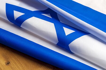 Top view of flag of Israel lies on wooden tableの写真素材