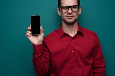 Portrait of a positive young man in glasses