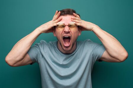 Portrait of a tired desperate young man in glassesの写真素材