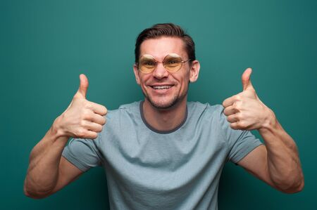 Portrait of a positive young man in glasses