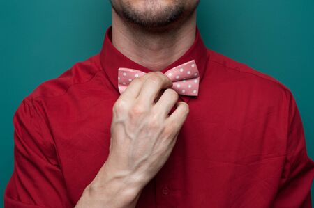 Close-up of the hands of a young man in red shirtの写真素材