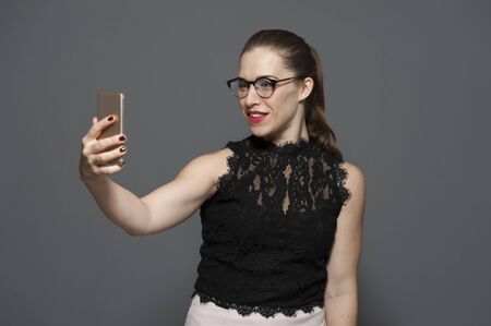 Charming attractive young woman in glasses