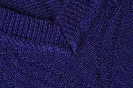 Close-up fragment of the neck knitted blue sweatshirt. Concept of warm autumn and spring things. Quality Woolen Clothing Concept. Sewing concertの写真素材