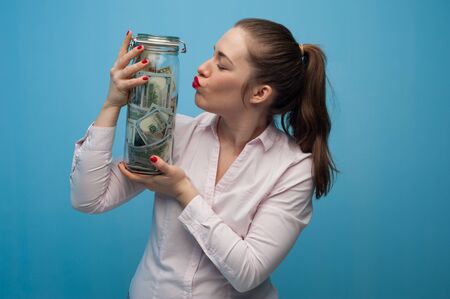 Young charming woman holds a jar