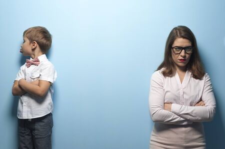 Angry young pretty mother and little naughty boy