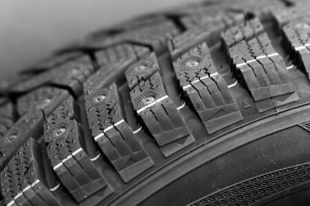 Close-up side view of a fragment of a car studded tire. Automotive industry concept. The concept of seasonal tire updates. Truck and motorcycle wheel conceptの写真素材