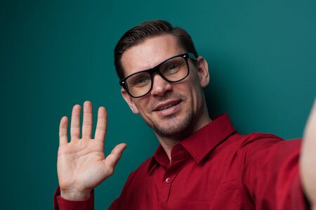 Portrait of a positive young man in glasses